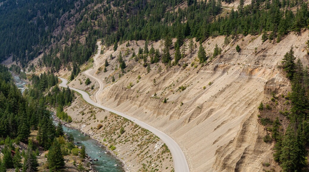 Aerial View of a Scenic Dirt Road towards Gold Bridge in the Valley surrounded by Canadian Mountain Landscape. Taken near Lillooet, British Columbia, Canada.