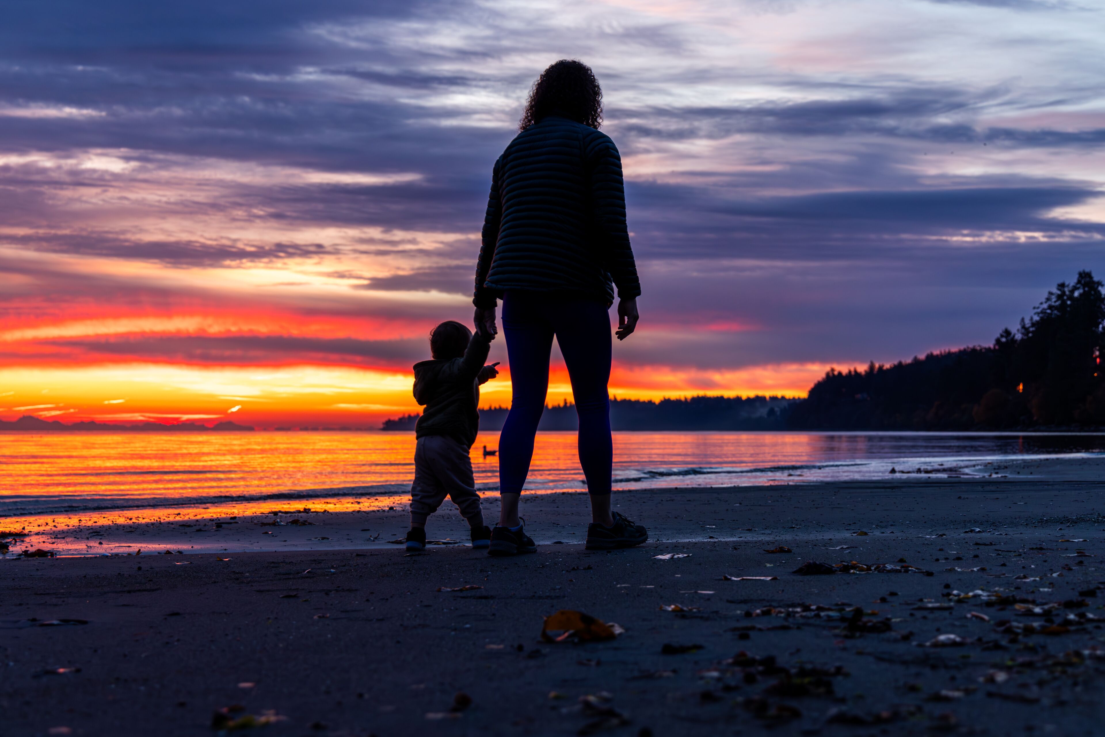 Parent and Child Enjoy Sunrise on Vancouver Island Beach