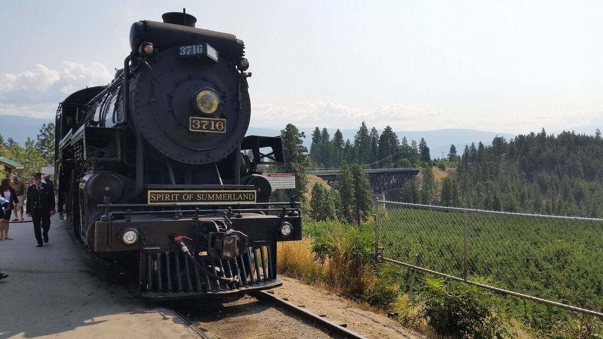 A steam locomotive named 'Spirit of Summerland' with the number 3716 on a railway track.