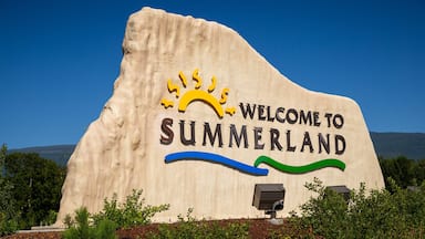 Un gran cartel de bienvenida a Summerland con un diseño de sol y olas.