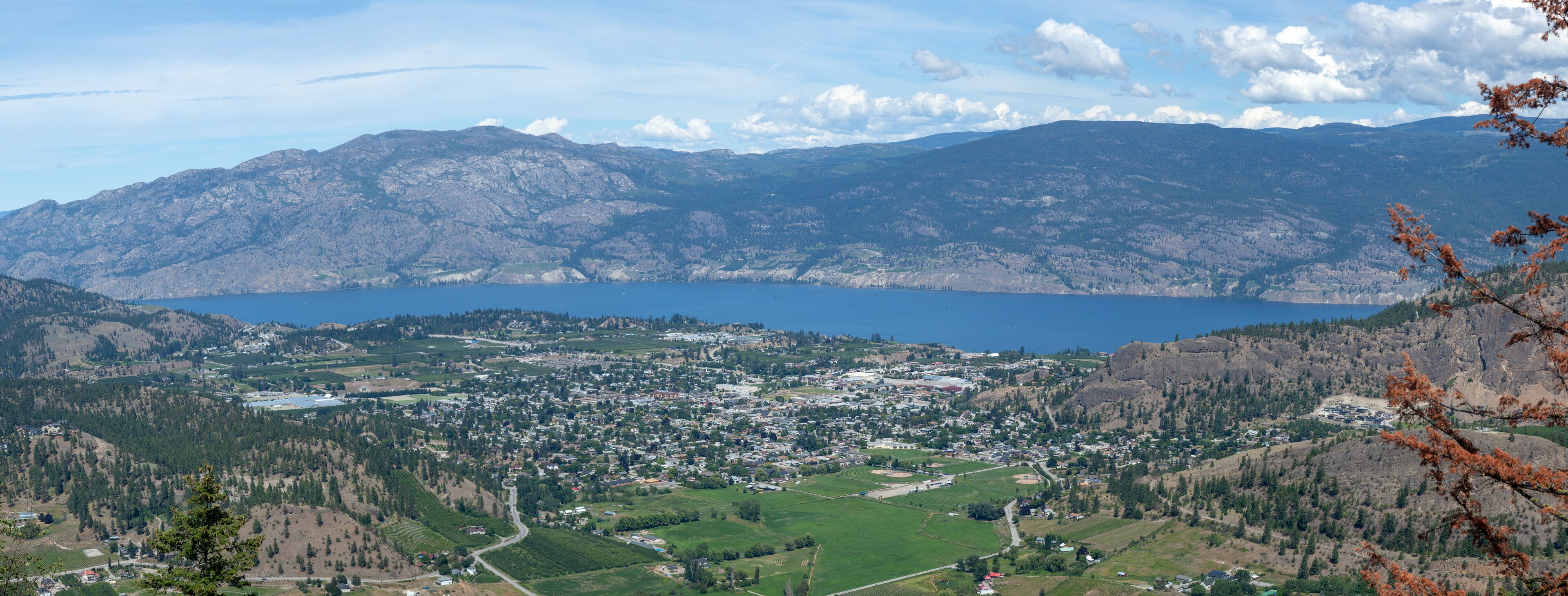 A mountainous landscape with a lake and a town.