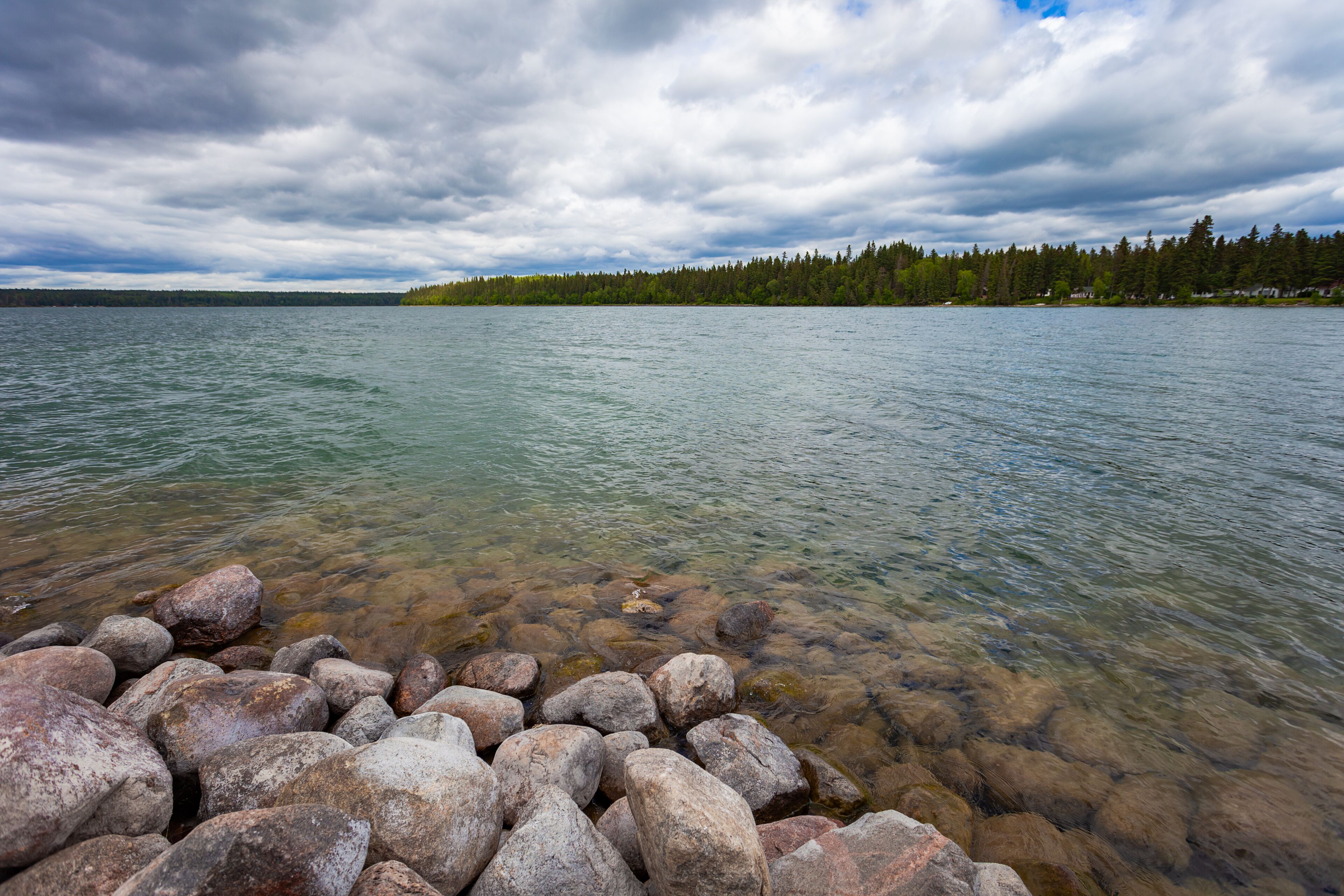 Rocky shore of Clear Lake in Wasagaming, Manitoba on a cloudy day