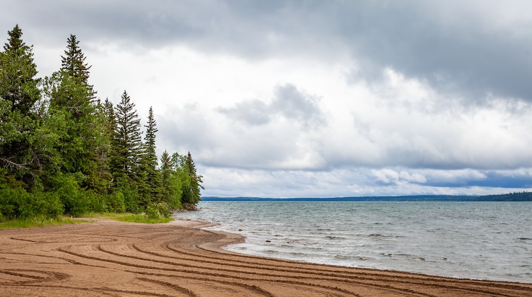 The sandy shore of Clear Lake in Wasagaming, Manitoba on a cloudy day