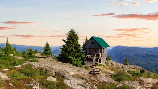 View of Tin Hat Cabin on top of a mountain. Dramatic Colorful Sunset Art Render. Located near Powell River, Sunshine Coast, British Columbia, Canada.
