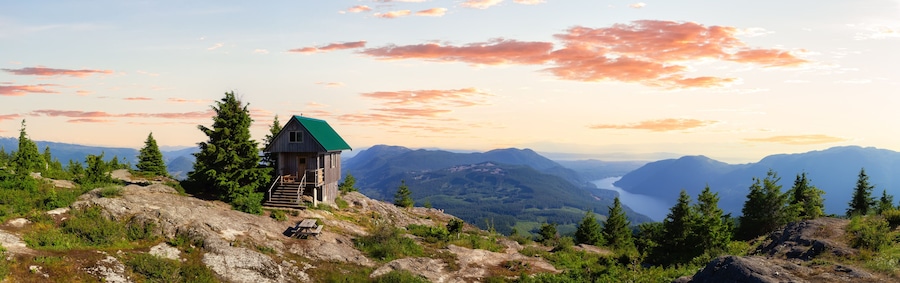 View of Tin Hat Cabin on top of a mountain. Dramatic Colorful Sunset Art Render. Located near Powell River, Sunshine Coast, British Columbia, Canada.