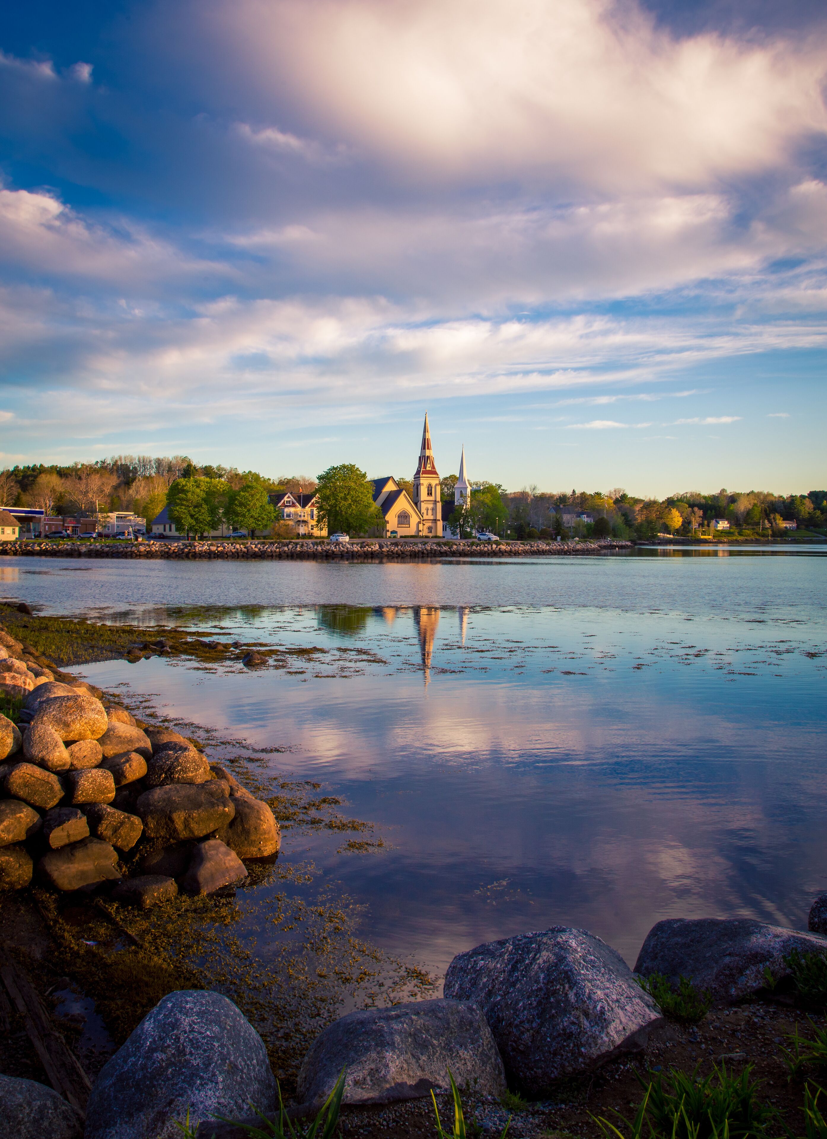 Church reflects in the water in Mahone bay