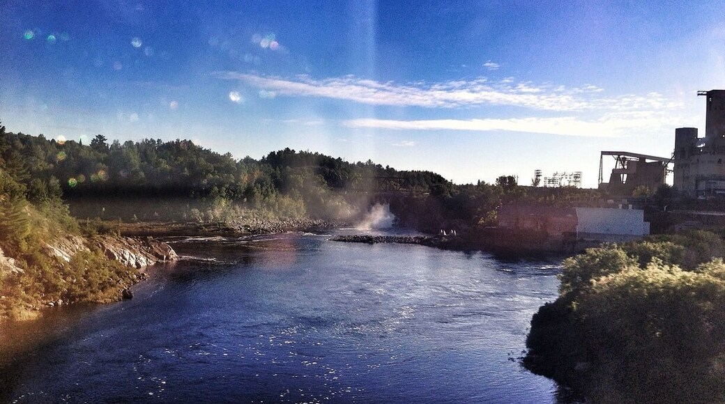 Hard to see in the distance but there's a cool dam way back.
I tried to get a shot of the massive factory beside it - but was blurry through the window.
So far I've counted 4 waterfalls and several dams along the Trans-Canada Hwy. also seen a beautiful hawk sitting atop a hay pile (would have made a great photo, and a few Hurons.
Anyone taking this trip with Greyhound Busses, a word of caution - Sudbury station is very sketchy, no coffee, dirty washrooms, vending machines only, and your in the middle of no where with homeless walking around. Keep an eye in your belongings at all times.
Almost approaching Sault Ste Marie Ontario (where I was born). Ironic enough I haven't lived here since I was a toddler and now I'm back on my birthday. Kinda cool I think.