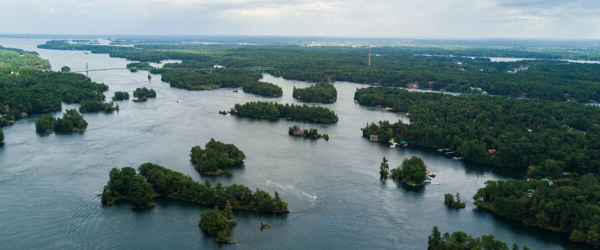 An aerial view of a river with numerous small islands covered in dense greenery.
