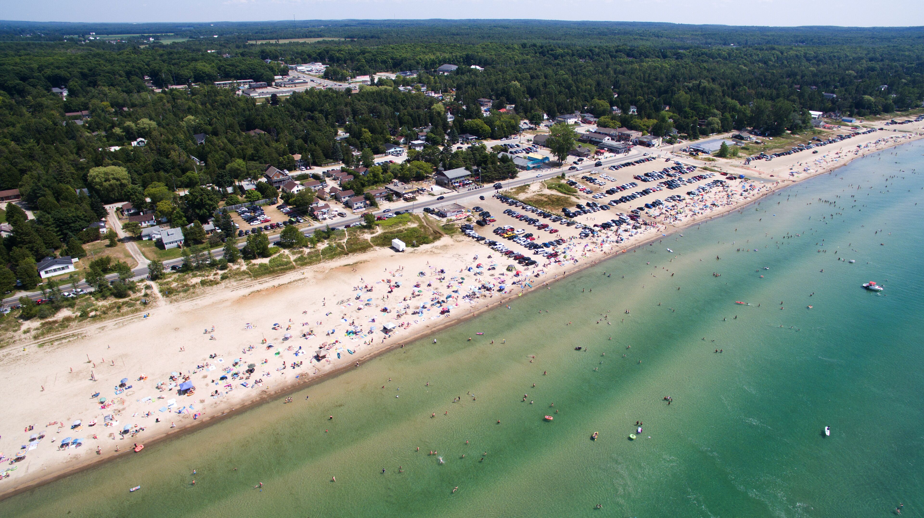 People enjoy the sandy beach at Sauble Beach, Ontario, Canada