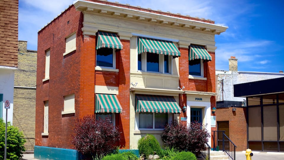 A red brick building with green and white striped awnings, a 'Four' sign, and a fire hydrant.
