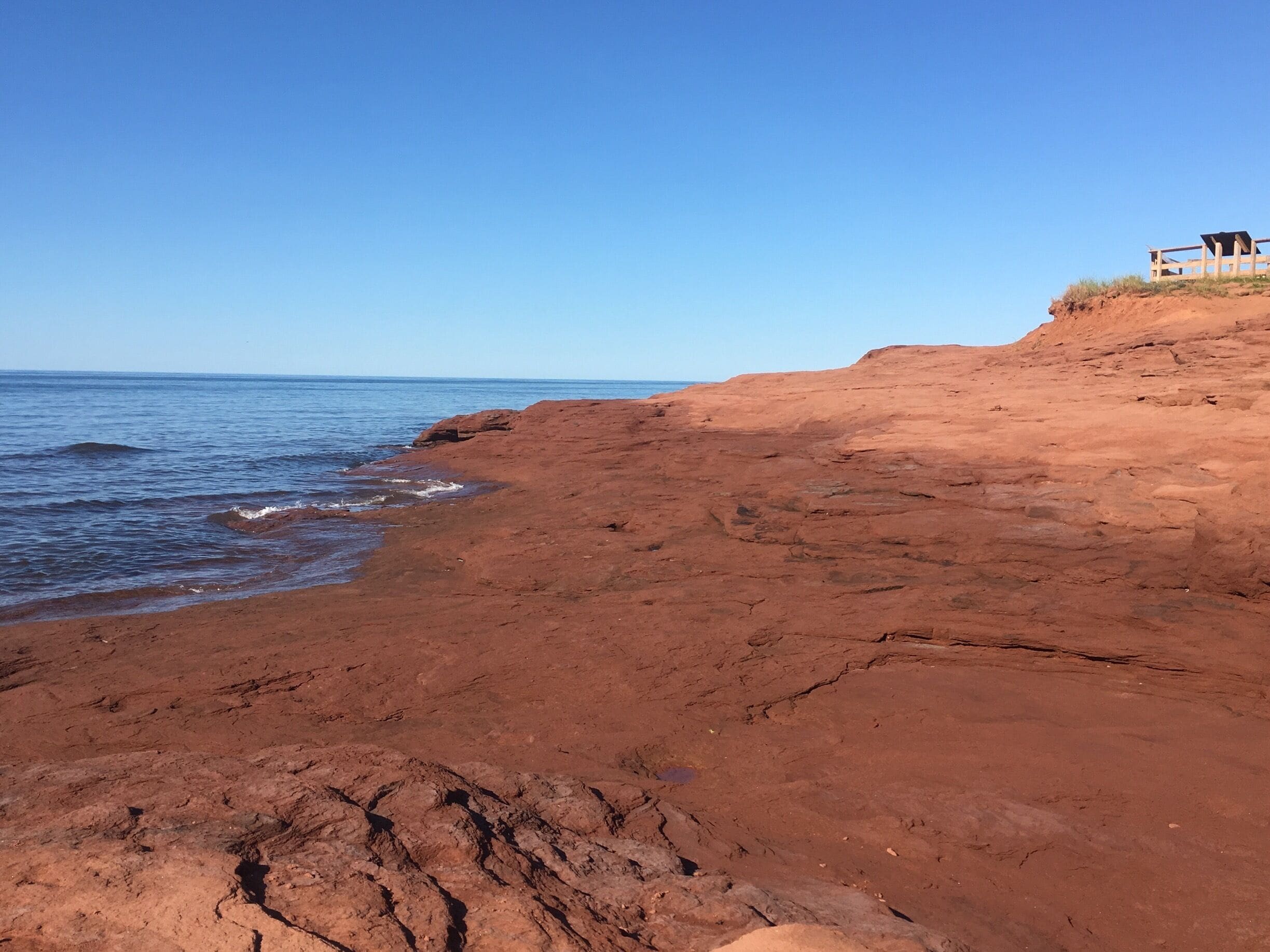 A rocky coastline with a clear blue sky.
