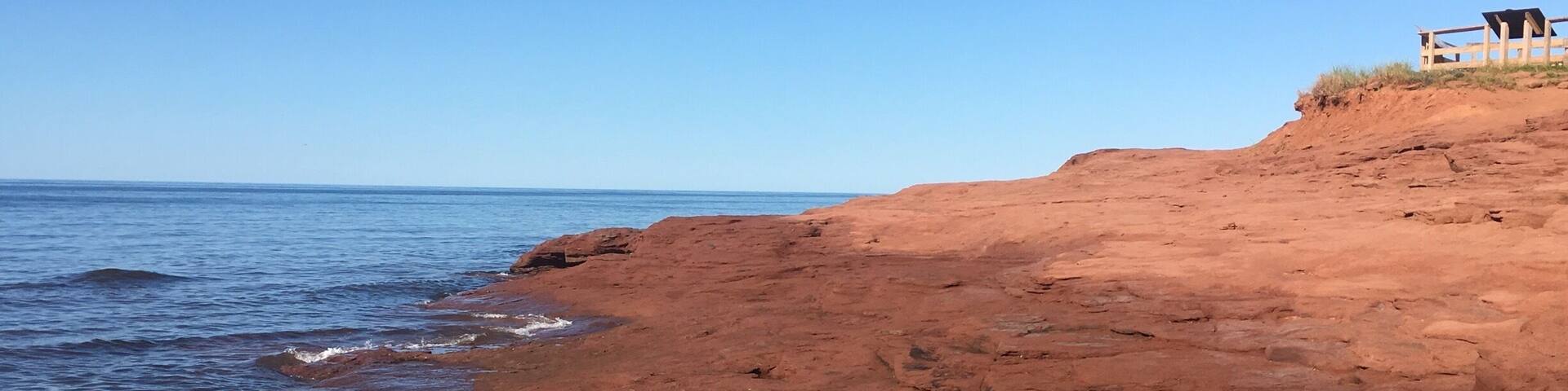 A rocky coastline with a clear blue sky.
