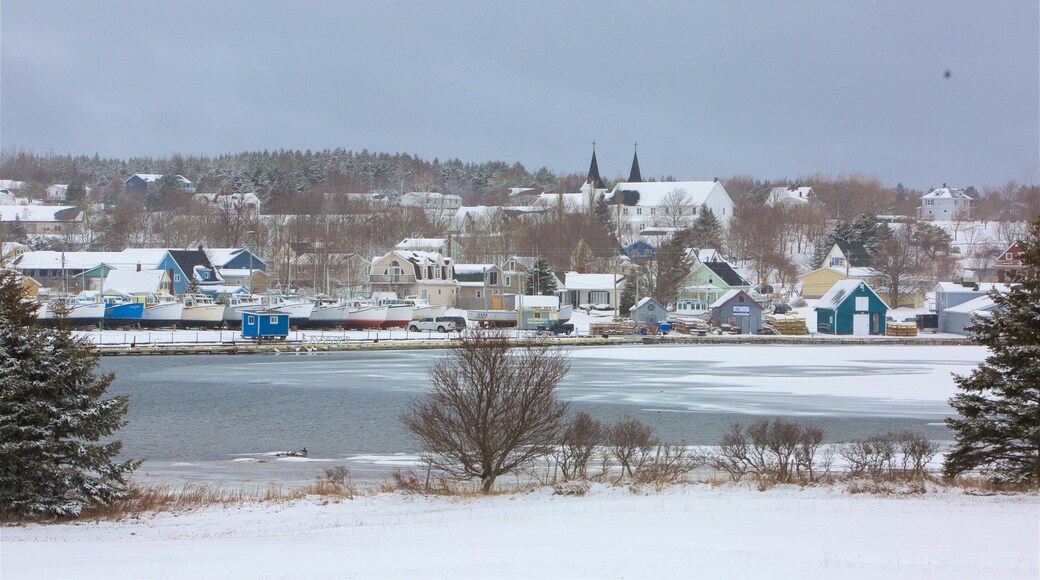 North Rustico showing a lake or waterhole, snow and a small town or village