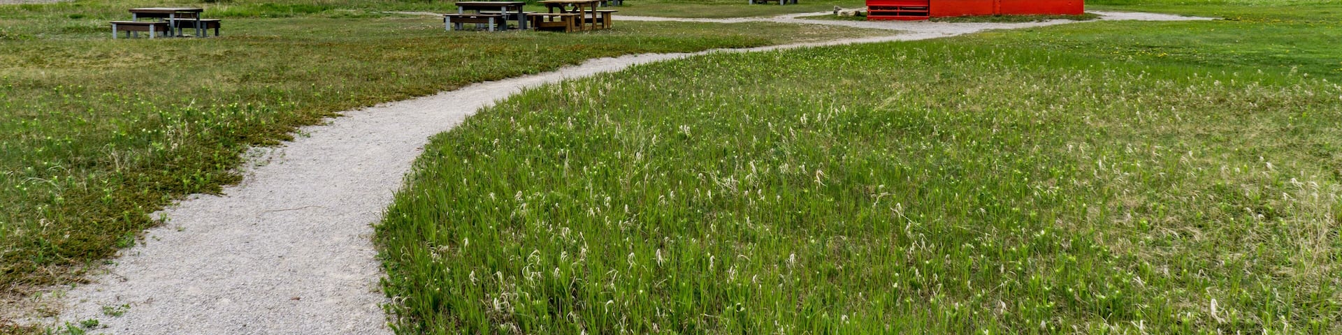 View on the small but cute Carleton's lighthouse with a view on the Mount St Joseph in the background, located in Quebec, Canada