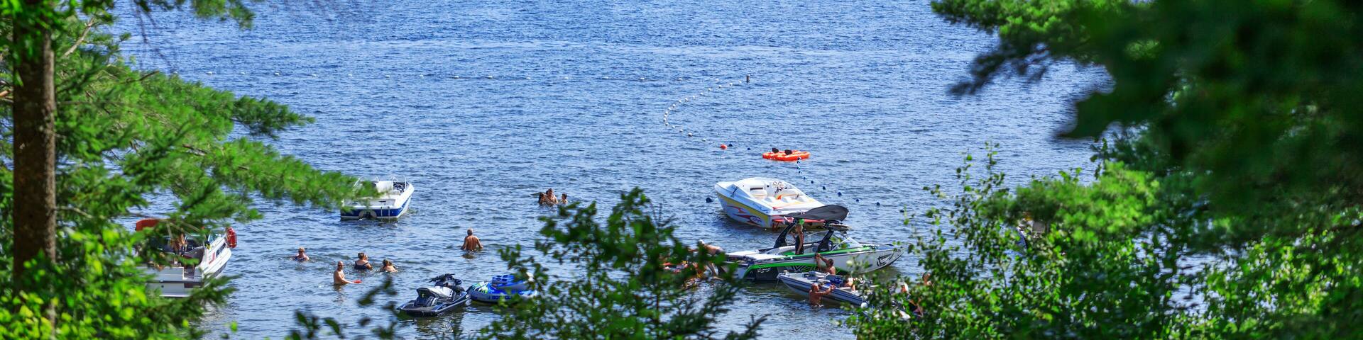 Lac-Simon, Quebec, Canada – July 29, 2018: Amazing view of Lac-Simon sightseeing resort. Lake beach, mountain and hills landscape with beautiful skyline.
