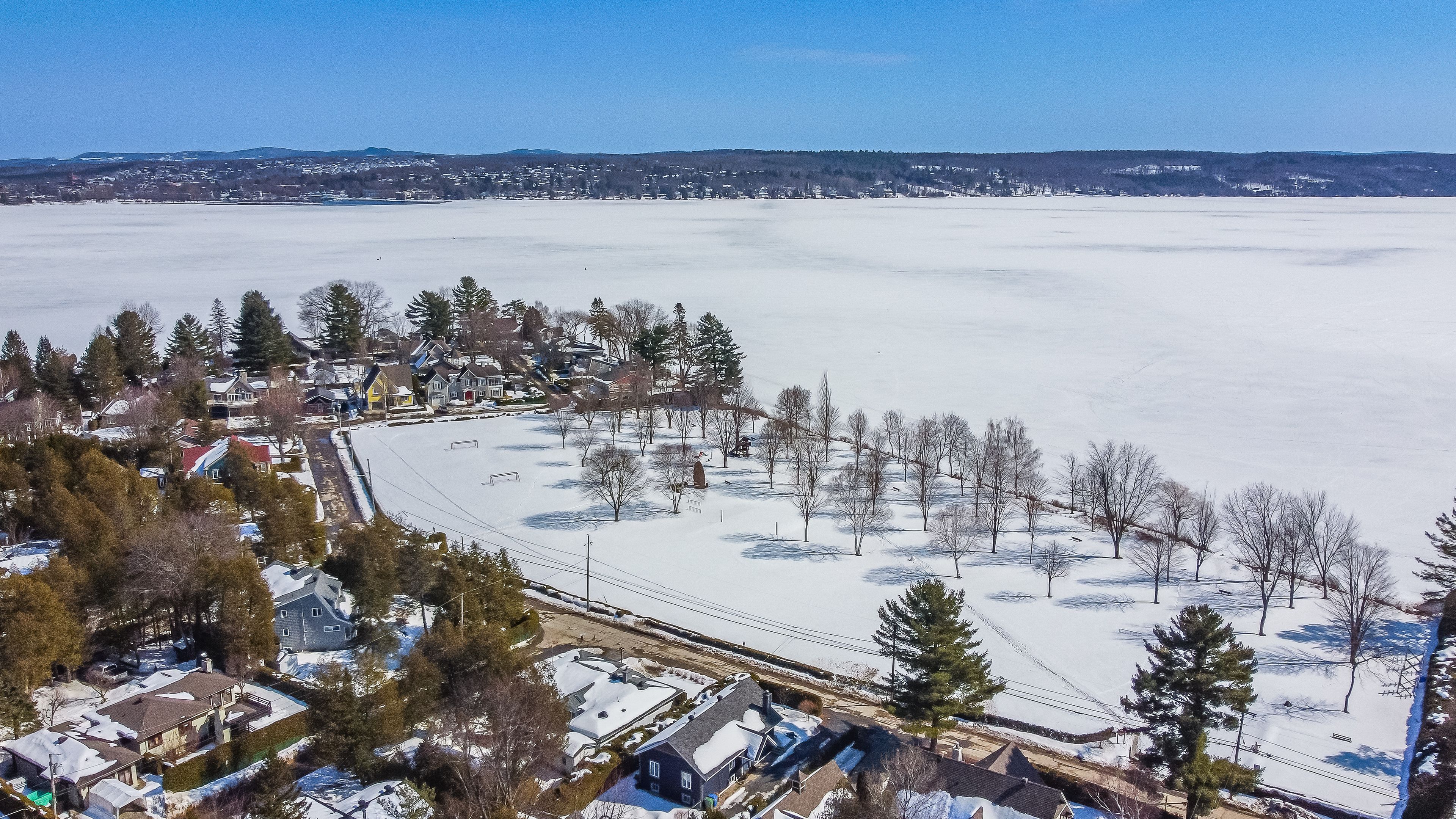 Flying over the cherry river in the Estrie region in winter in Quebec