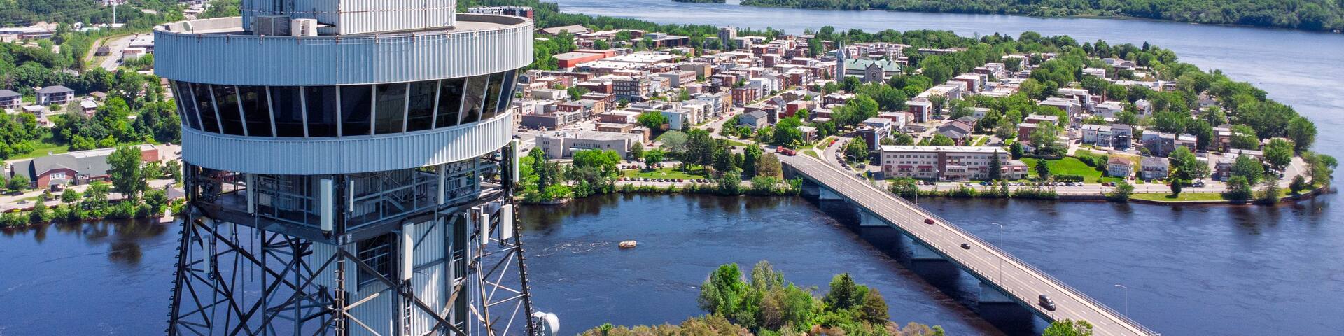 A river with a bridge, a tower, and a town.