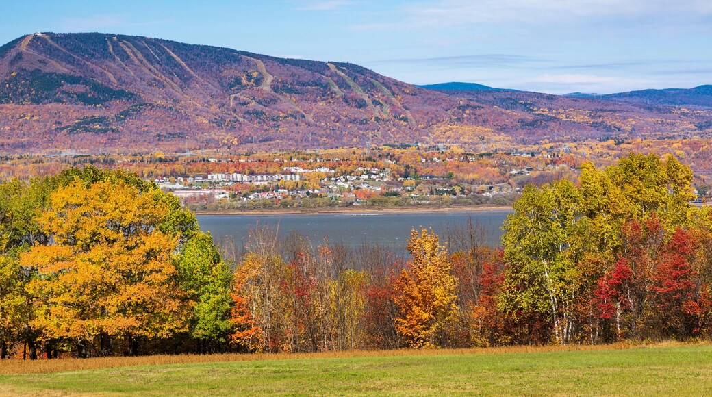 View from Ile d'Orleans of Saint-Lawrence river and Saint-Ferreol-les-Neiges village with Mont-Sainte-Anne in the background in autumn., Quebec, Canad