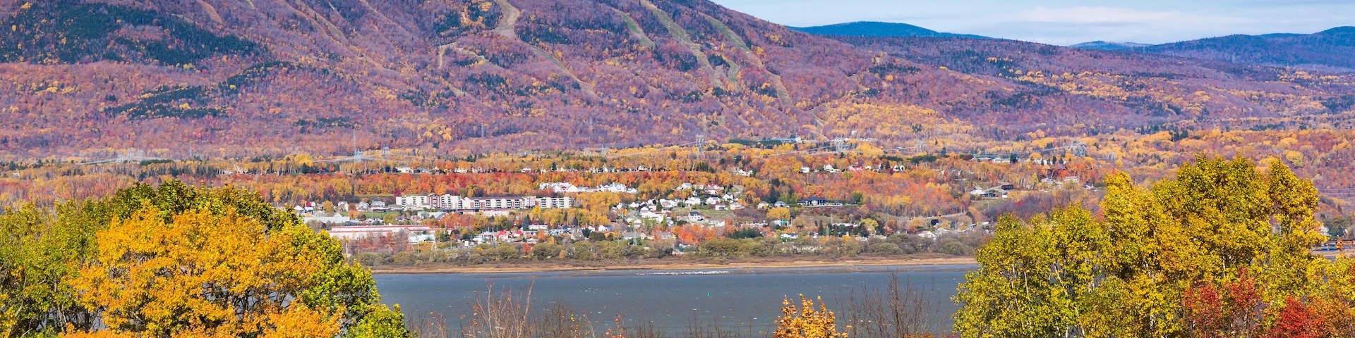View from Ile d'Orleans of Saint-Lawrence river and Saint-Ferreol-les-Neiges village with Mont-Sainte-Anne in the background in autumn., Quebec, Canad