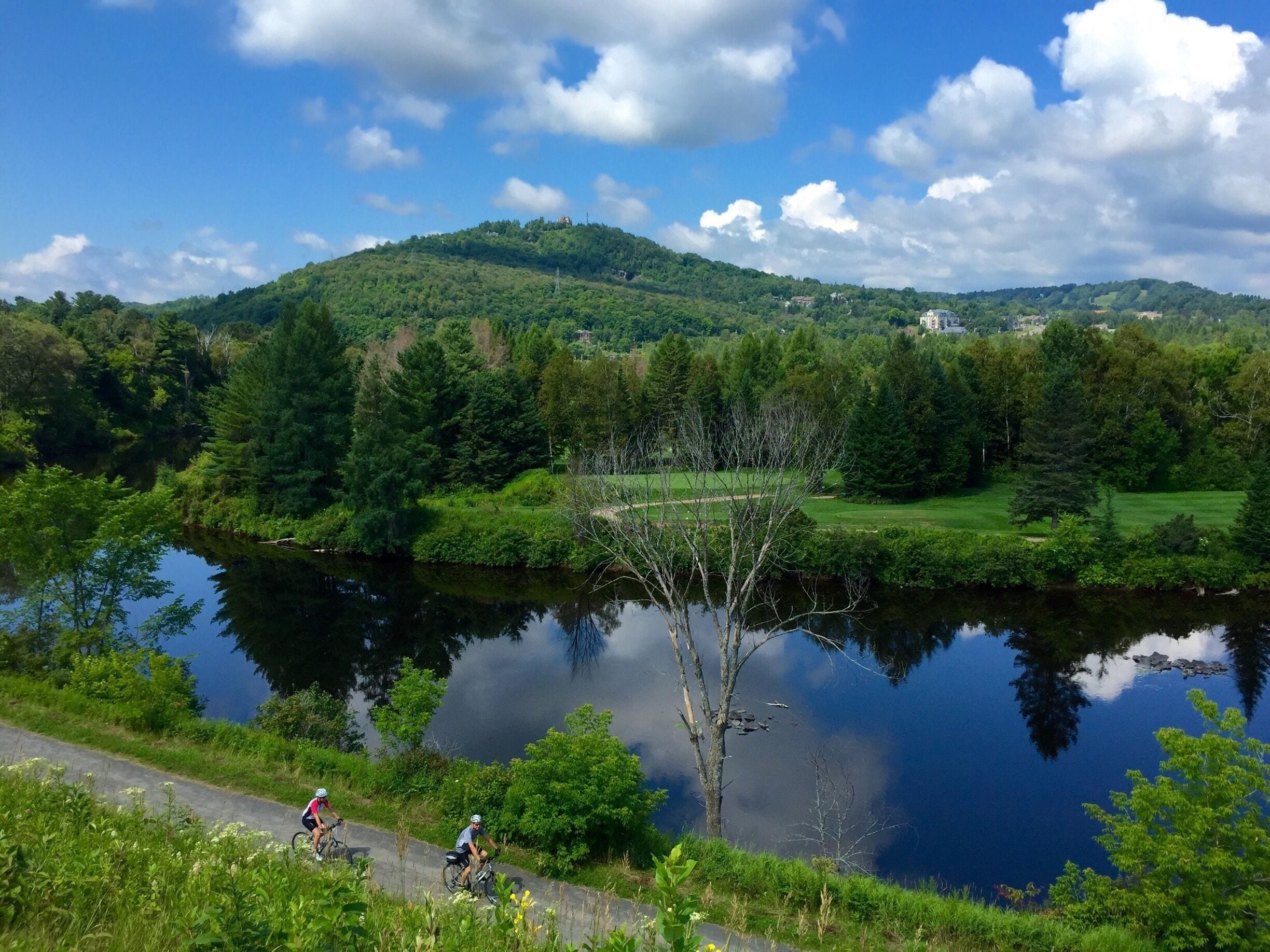 Biking along the Train Du Nord trail towards Mt Tremblant.  Beauty - everywhere!! 

Biking the Train du Nord trail in Ste. Adele. 

The trail runs for 200 kilometres (124 miles) between Saint-Jérôme and Mont-Laurier and is used for biking, cross-country skiing and hiking.

The Parc Linéaire Le P'tit Train du Nord is a multi-use recreational rail trail located in Quebec. It originally was a railway track operated by Canadian Pacific Railway, Inc., which reportedly operated it at a continuous financial loss ever since its construction in the 1890s, before dismantling it during the 1990s to make way for today's beautiful recreational trail—save for the portion between Montréal and Saint-Jérôme which is still in service. 



#Green

#Green