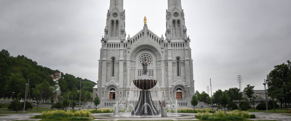 A large cathedral with twin spires and a central statue.