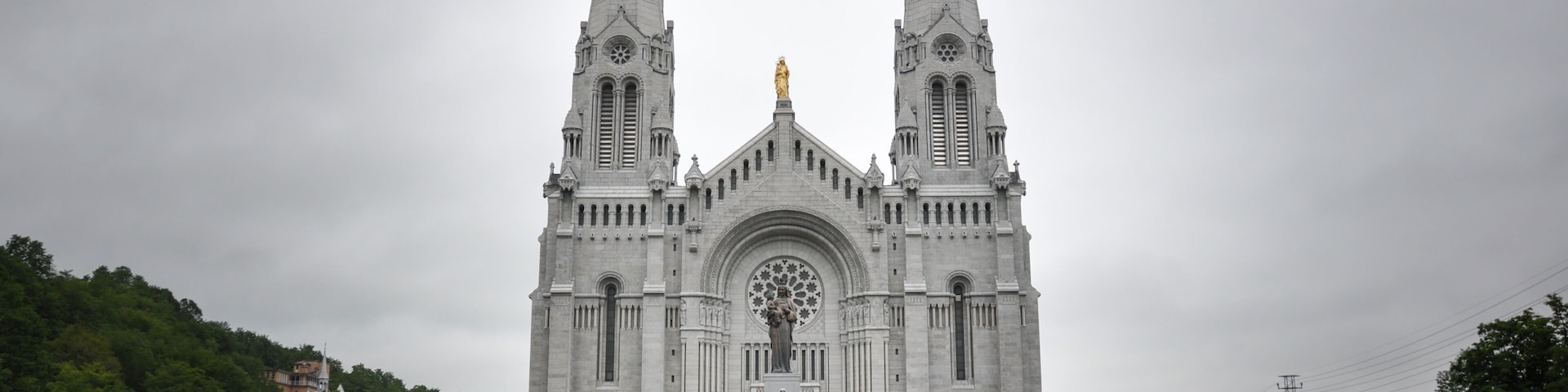 A large cathedral with twin spires and a central statue.