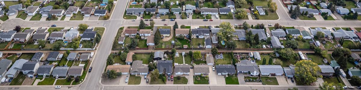 A residential area with houses, streets, and green spaces.