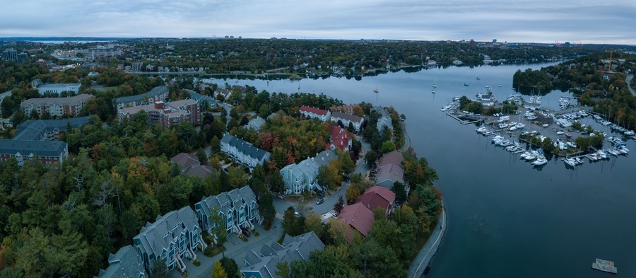 Aerial panoramic view of Melville Cove in the Modern City during a cloudy sunrise. Taken in Armdale, Halifax, Nova Scotia, Canada.