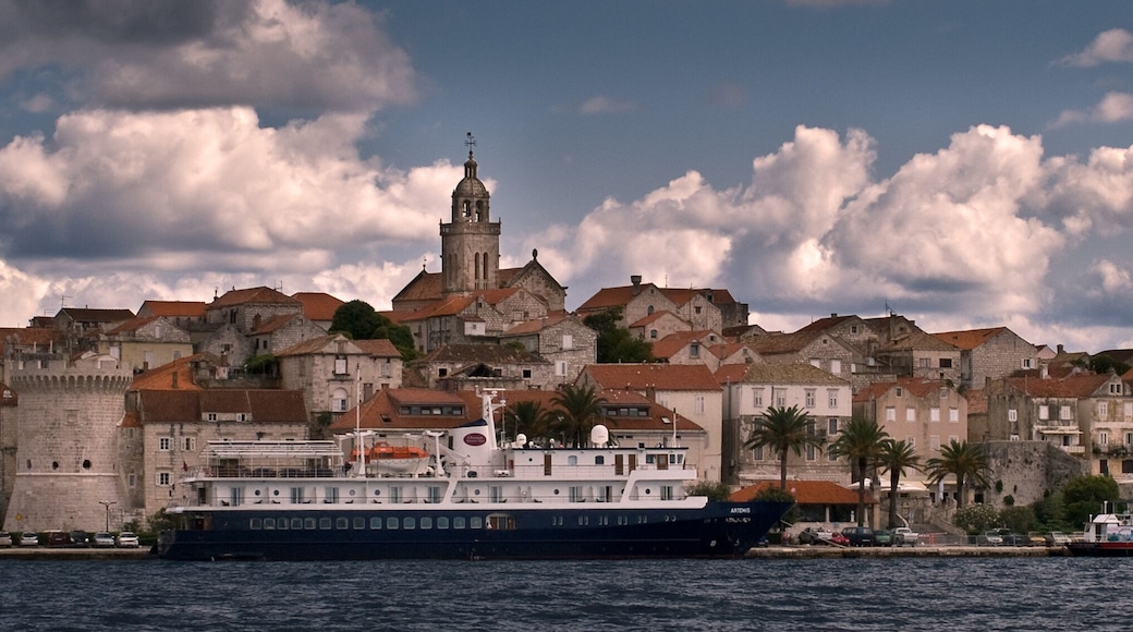 Seaview of a fortified city with sky and clouds.