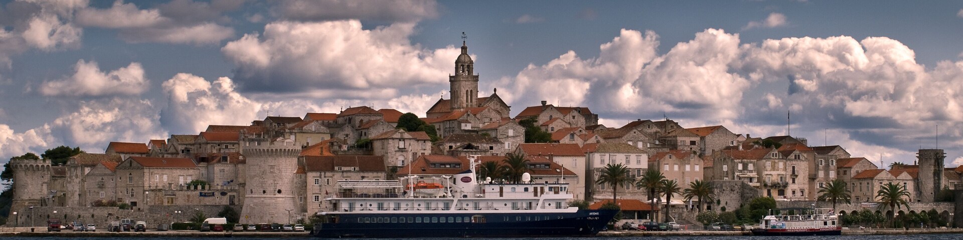 Seaview of a fortified city with sky and clouds.