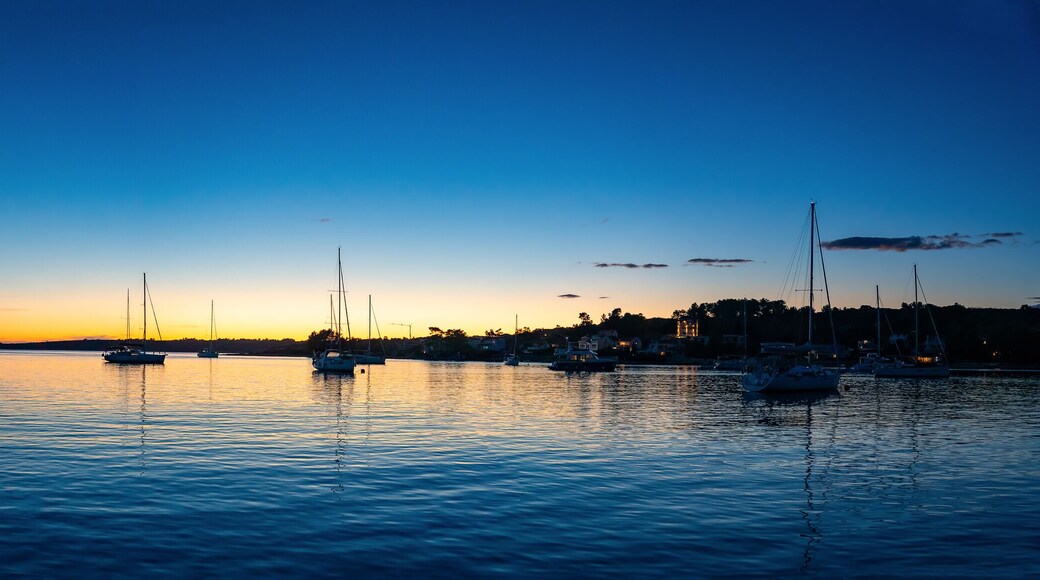 Panorama view of Yachts moored on buoys near the shore in the bay of Uvala Gradina near the town of Vela Luka on the island of Korcula at night time in Croatia