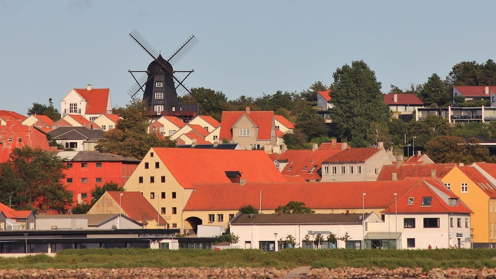 Black windmill and houses in Ebeltoft, Denmark.