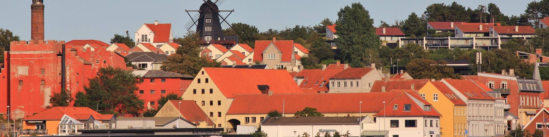 Black windmill and houses in Ebeltoft, Denmark.
