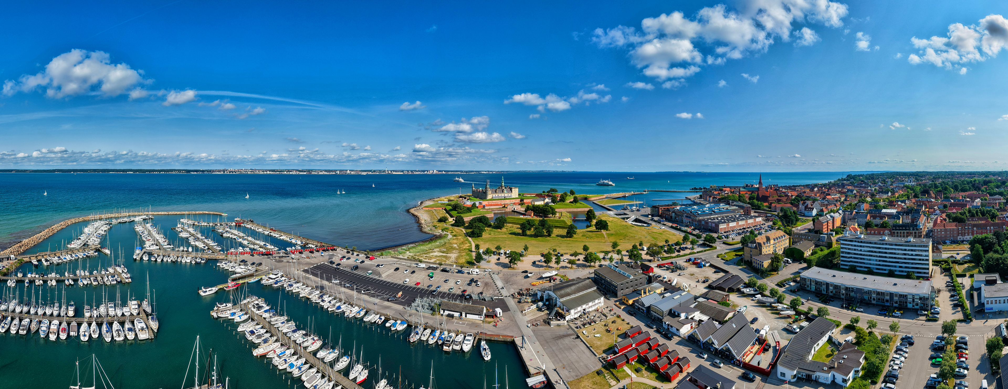 A coastal town with a marina, historic buildings, and a church.