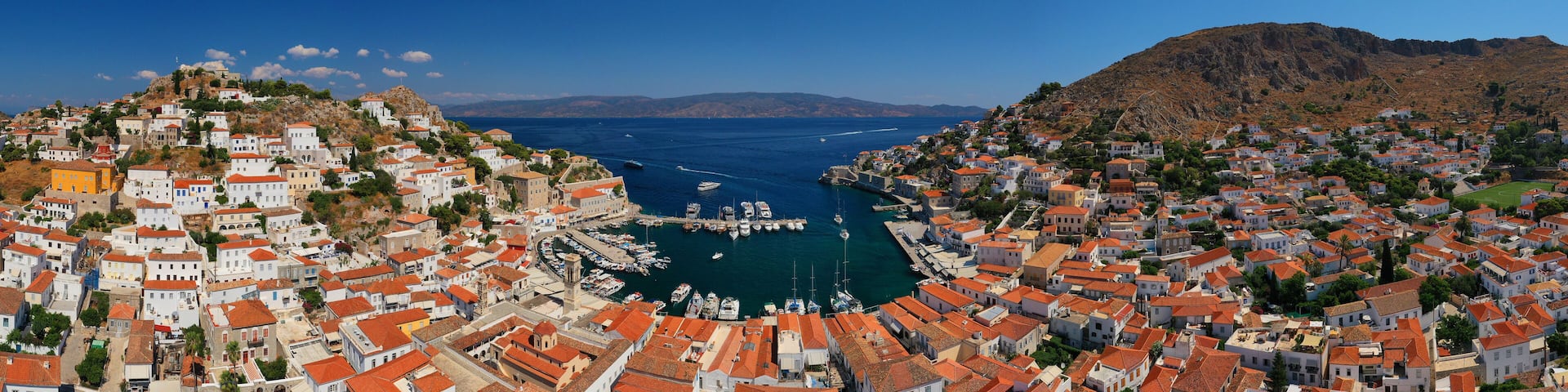 Aerial drone panoramic photo of picturesque port and main village of Hydra or Ydra island with beautiful neoclassic houses, Saronic gulf, Greece
