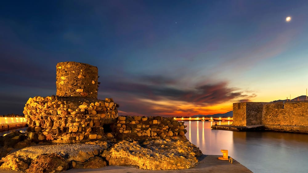 The entrance of the old harbor of Ierapetra, Crete, Greece. To the left ruins of an old lighthouse, to the right, a Venetian castle called "Kales"