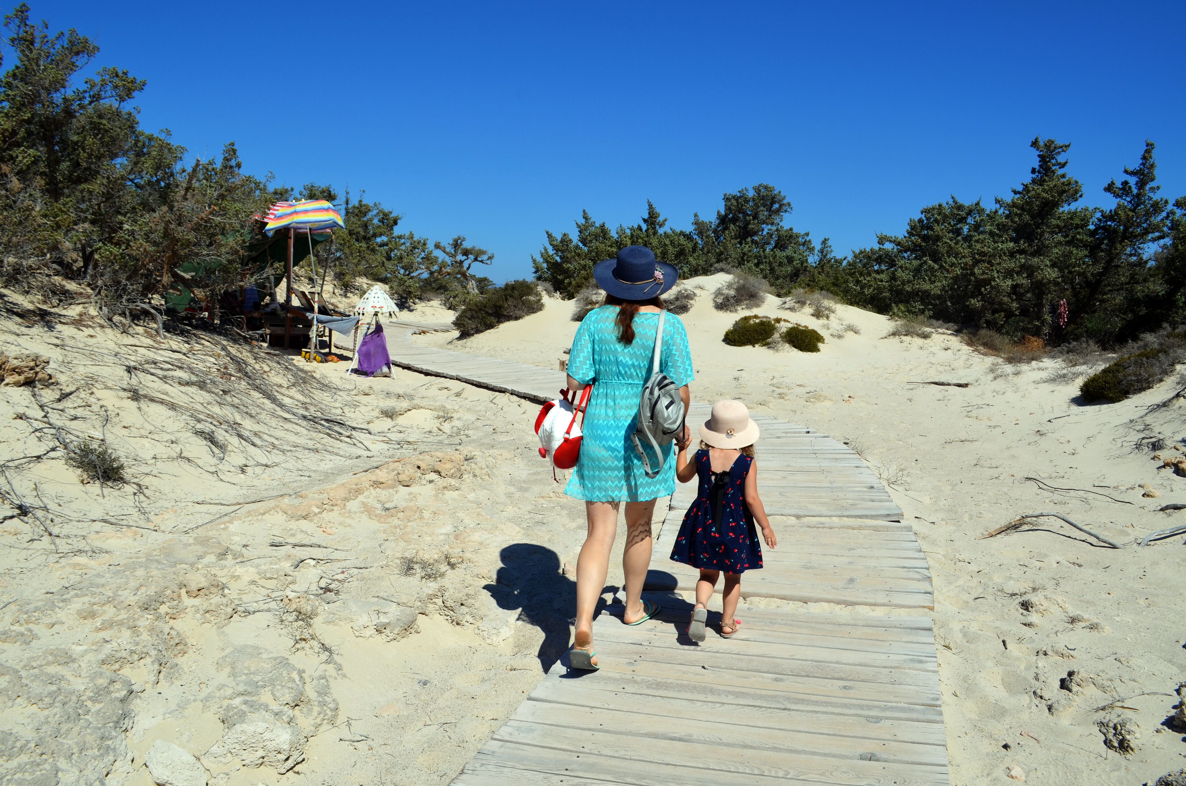 A mother and a daughter are walking around Chrissi island, Greece