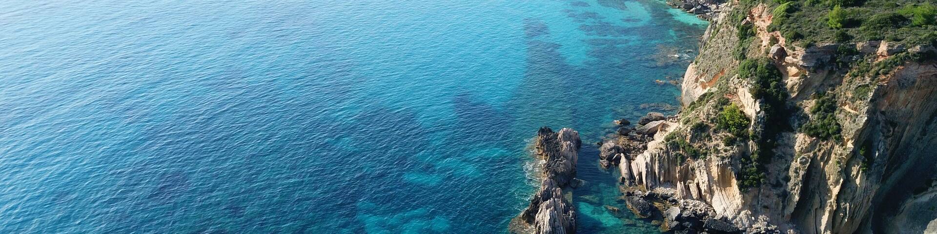Aerial drone photo of iconic white rock cliffs and volcanic formations near famous beach of Platys and Makrys gialos with turquoise clear sea, Argostoli, Cefalonia island, Ionian, Greece