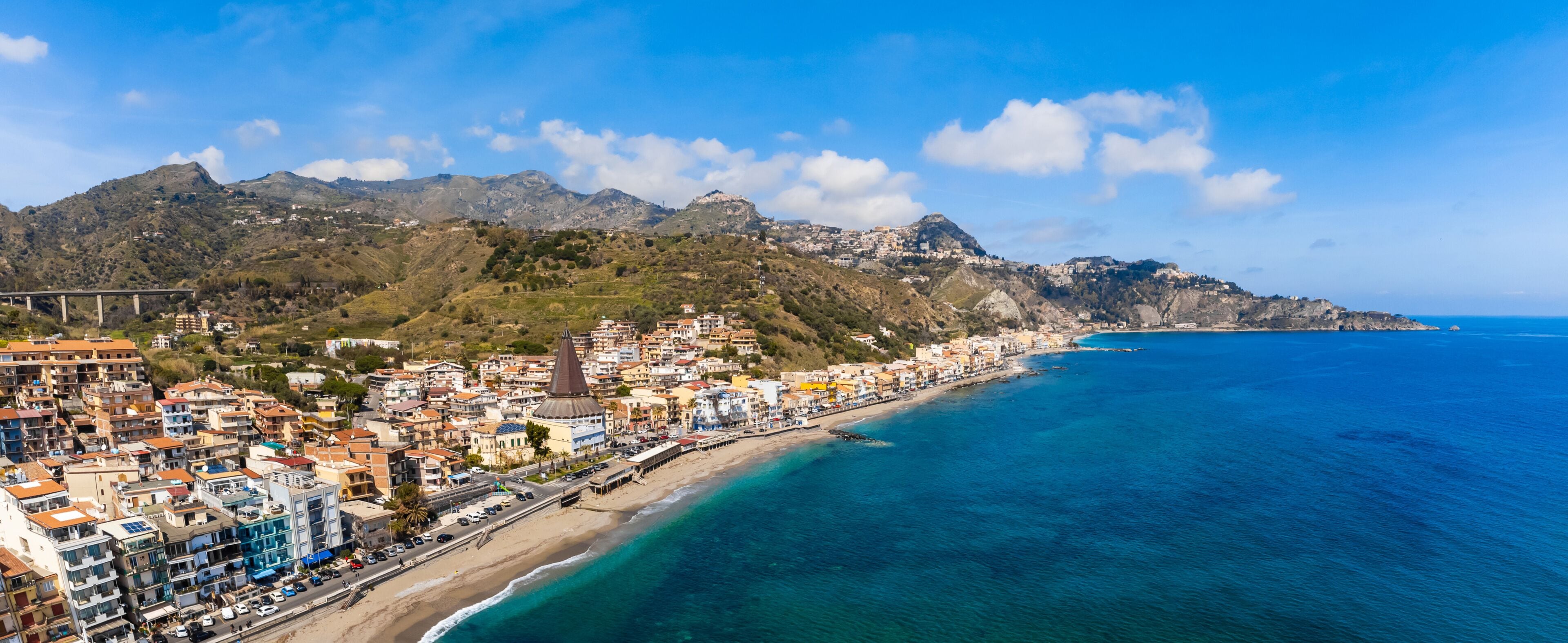 View with Giardini Naxos and Taormina, Sicily. Beach and sea in summer