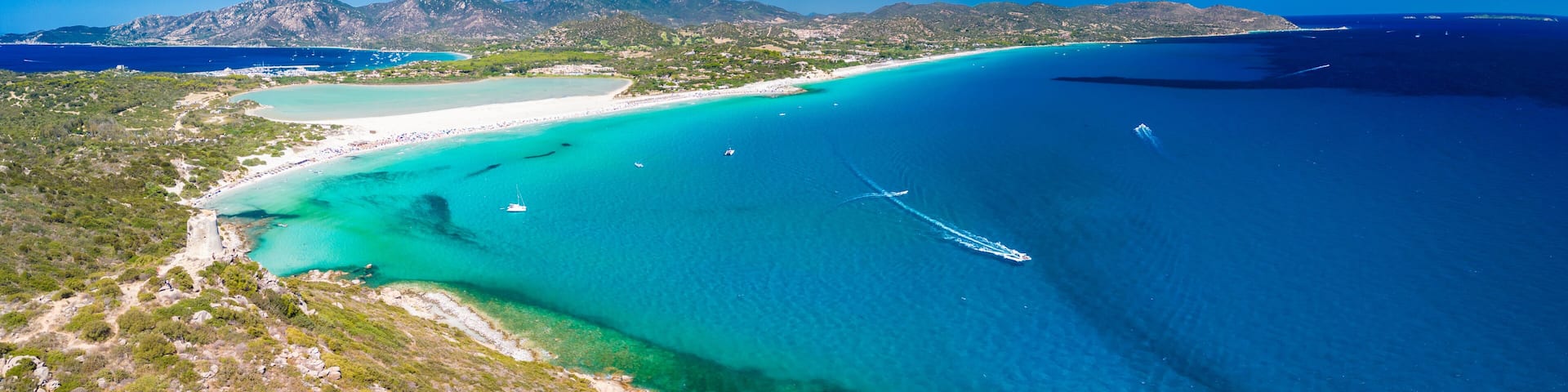 Aerial view of Porto Giunco beach and tower in Villasimius, Sardinia, Italy
