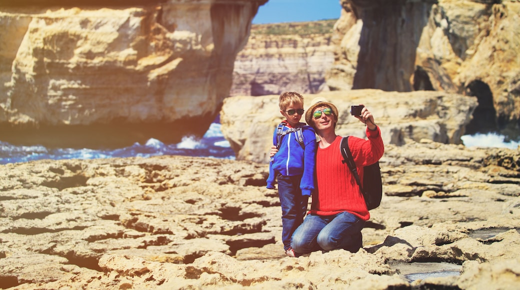 family travel- father and son taking photos in Gozo island, Malta