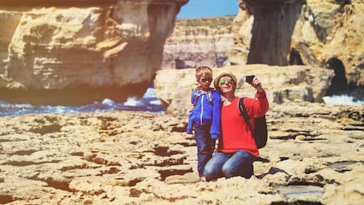 family travel- father and son taking photos in Gozo island, Malta