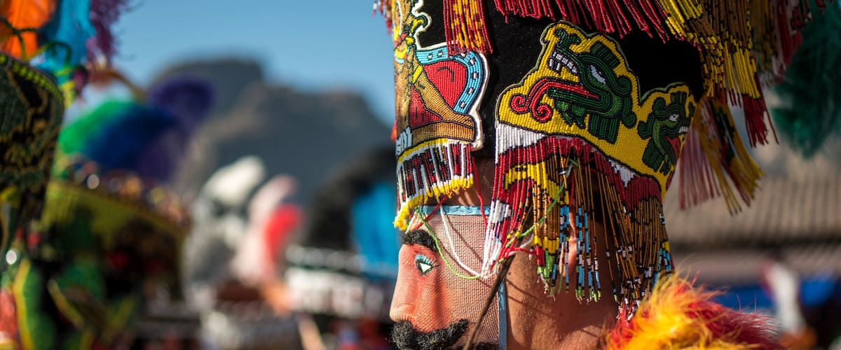 A colorful traditional headdress with intricate beadwork and tassels.