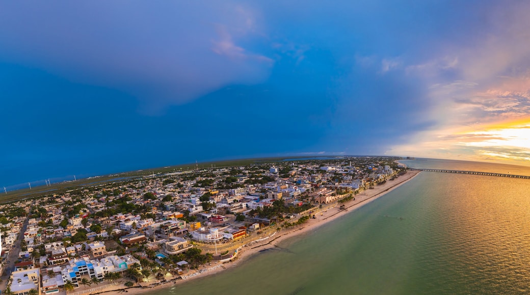 Aerial view of the vivid contrast between the dark blue sky and the warm sunset over the ocean and the cityscape, Progreso, Yucatan, Mexico.