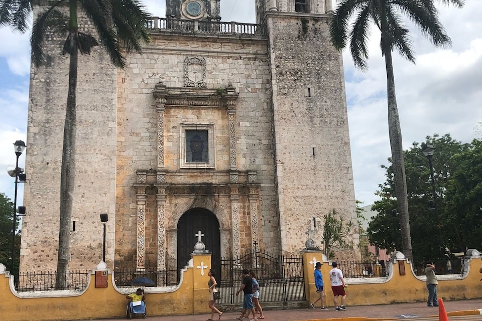 A historic church with two bell towers and a clock.