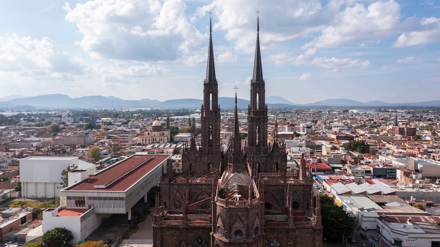 Zamora, Michoacán, Mexico - December 24, 2023: Afternoon light shines on a historic church in the heart of downtown Zamora.