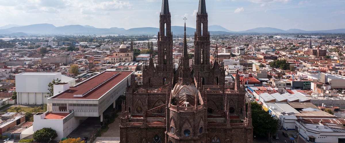 Zamora, Michoacán, Mexico - December 24, 2023: Afternoon light shines on a historic church in the heart of downtown Zamora.