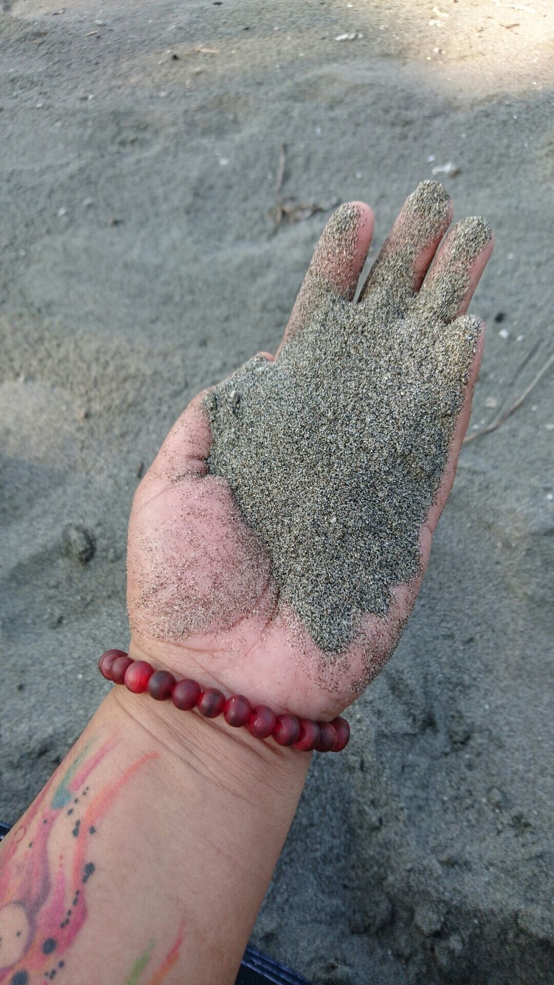 Powdery black sand. Too bad, mobile can't capture the sparks.