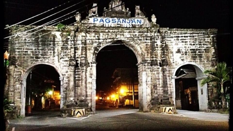 An old stone archway with the inscription "PAGSANJAN 1870-1880" at the top.
