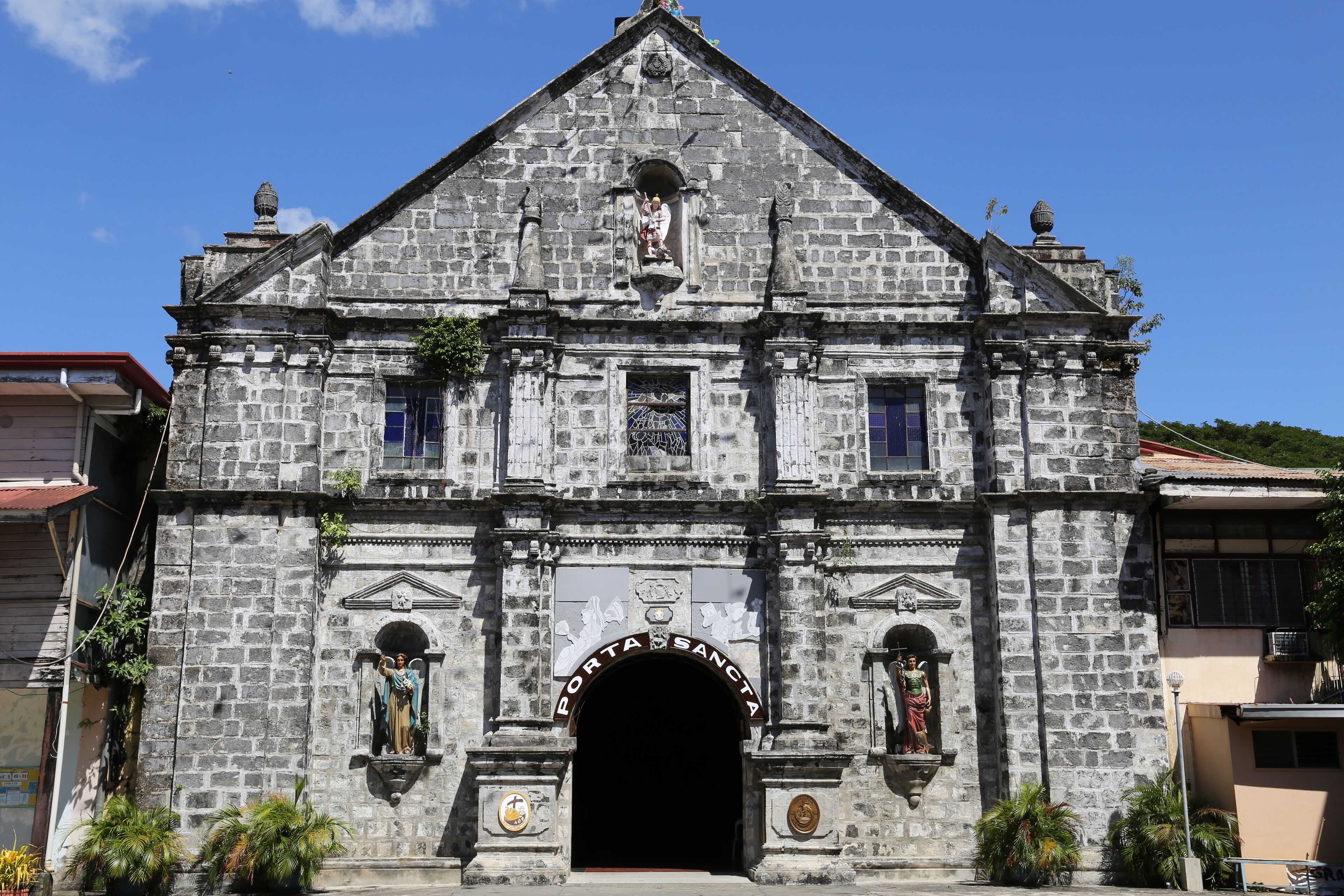 A historic stone church with a prominent entrance and statues.